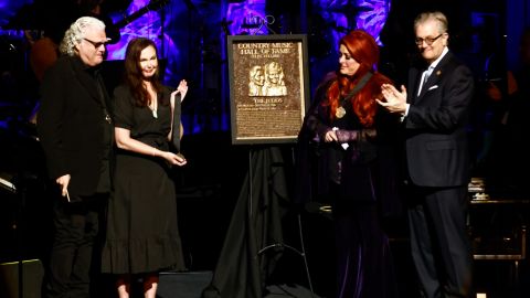 Wynonna Judd, second from the right, stands next to The Judds' induction plaque as sister Ashley Judd, left, Ricky Skaggs, and MC Kyle Young, CEO of the Country Music Hall of Fame & Museum look on during the Medallion Ceremony at the Country Music Hall of Fame on Sunday.