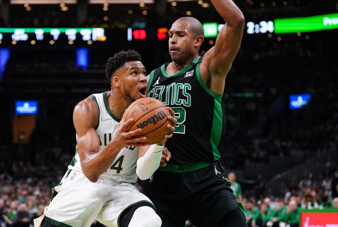 'The Greek Freak' drives the ball against Celtics center Al Horford.