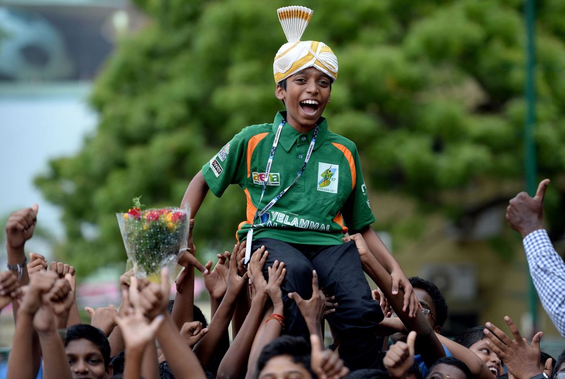 Pragg laughs as he is celebrated by his school upon his arrival back in Chennai on June 26, 2018, after becoming the world's second youngest chess grandmaster ever.