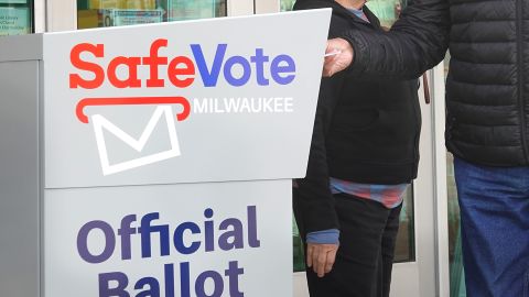 Residents drop mail-in ballots in an official ballot box outside of the Tippecanoe branch library on October 20, 2020 in Milwaukee, Wisconsin.
