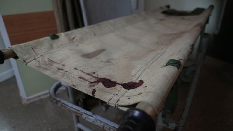 A bloody gurney lies in the hallway of a hospital in Bakhmut.