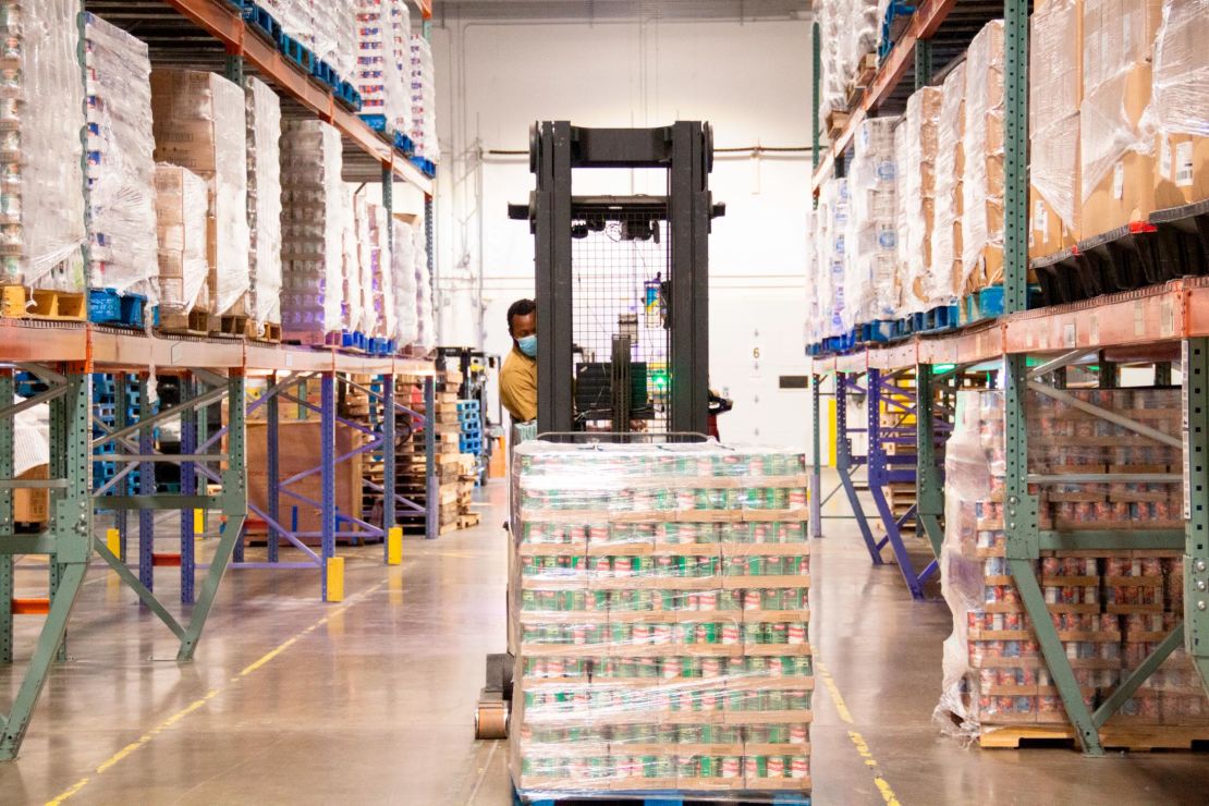 A Second Harvest Heartland staffer moves a pallet of canned goods in the food bank's warehouse in Brooklyn Park, Minnesota.