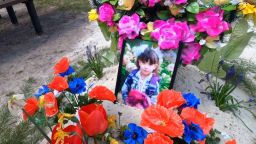 The grave of seven-year-old Anastasia, mourned by her grandmother, Galina.