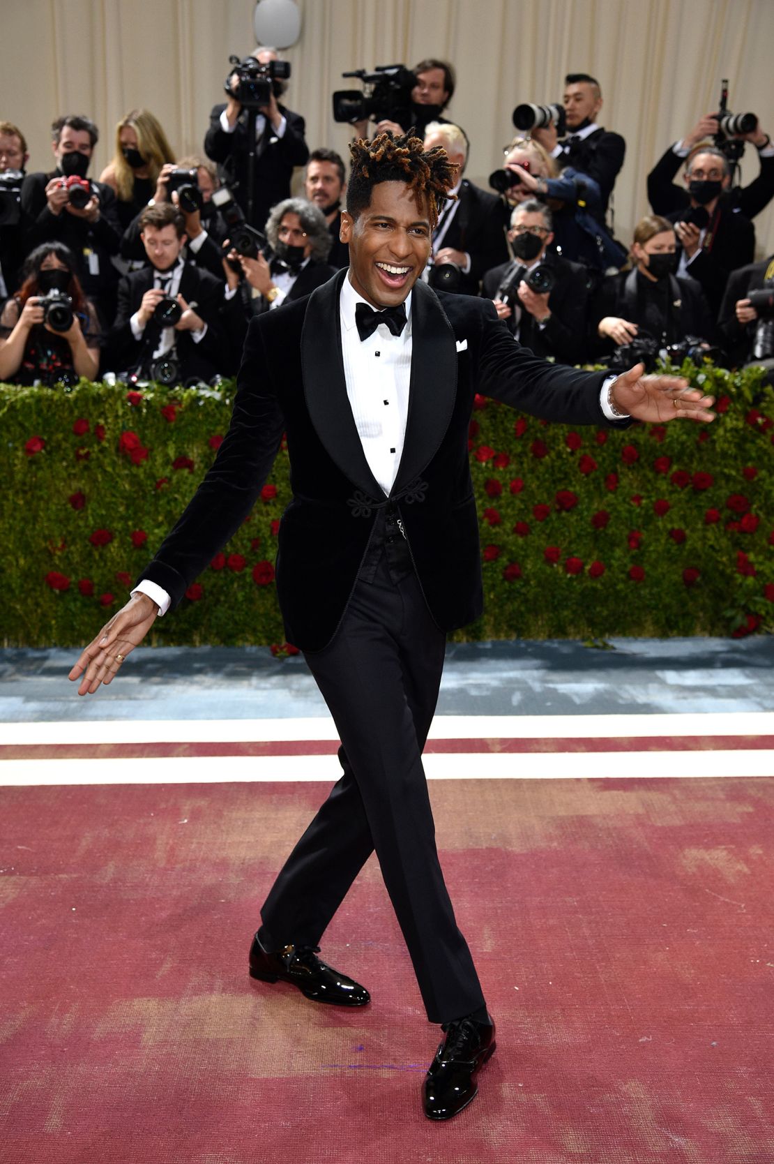 Musician Jon Batiste's Ralph Lauren tuxedo featured a black velvet dinner jacket and silk satin bow tie.  