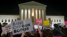 A crowd of people gather outside the Supreme Court on Monday night, May 2, 2022 in Washington.