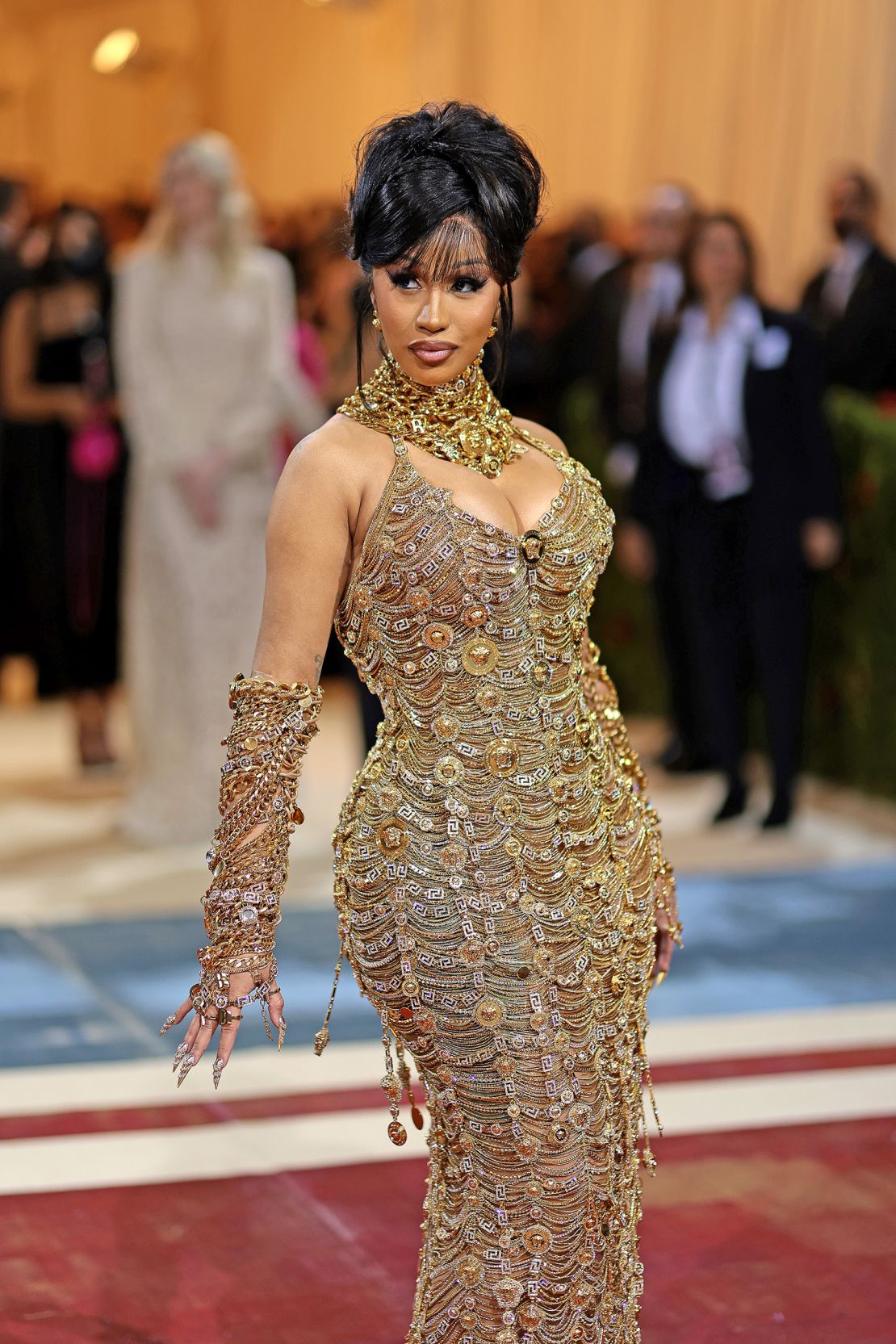 Rapper Cardi B turned to Versace for this chain-embellished dress, which was made from a mile of golden chains according to the brand. 