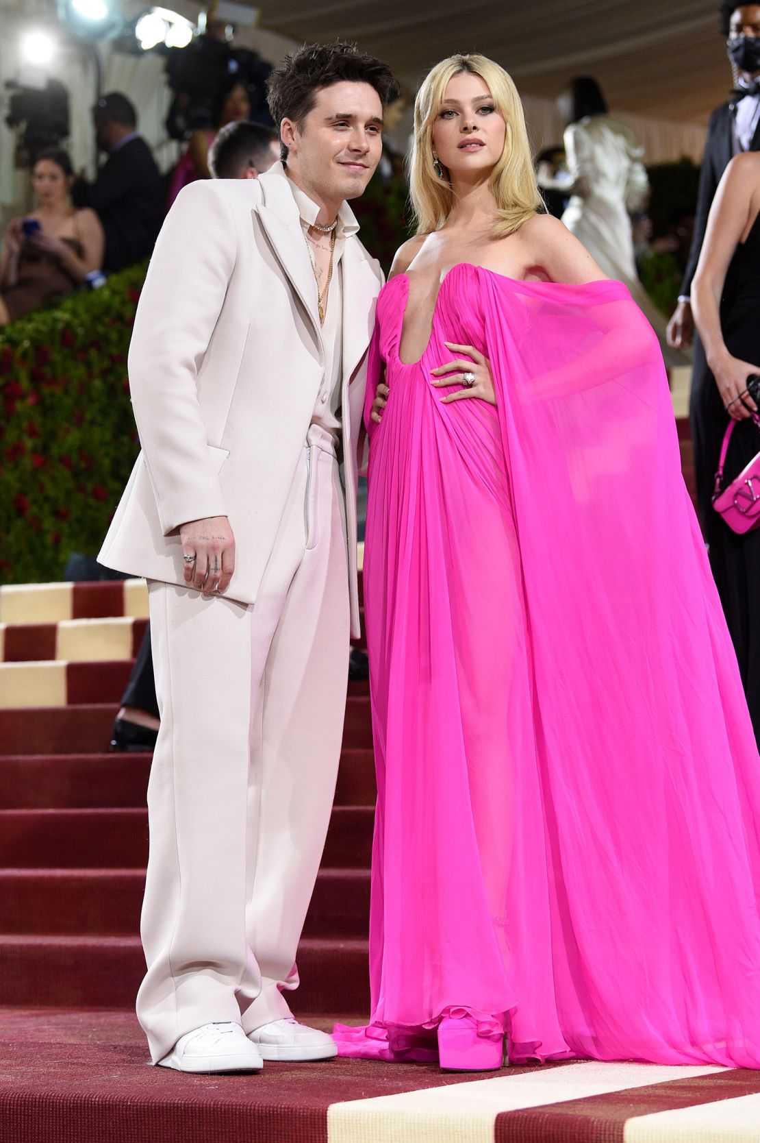 Brooklyn Beckham and Nicola Peltz both opted for Maison Valentino creations, with Peltz wearing a neon pink gown with a plunging neckline in contrast to Beckham's ivory suit.