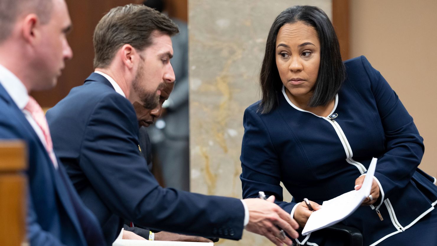 Fulton County District Attorney Fani Willis, right, talks with a member of her team during proceedings to seat a special purpose grand jury in Fulton County, Georgia, on Monday, May 2, 2022.