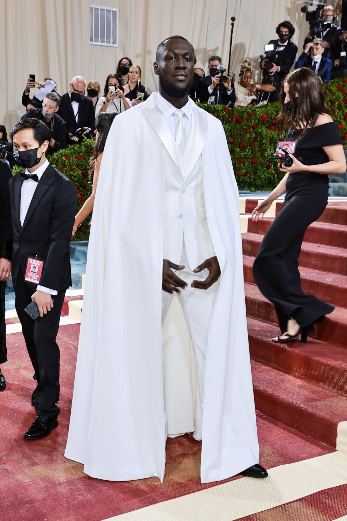 Stormzy departed from his usual wardrobe of dark clothing for a pristine white caped look by Ricardo Tisci for Burberry.