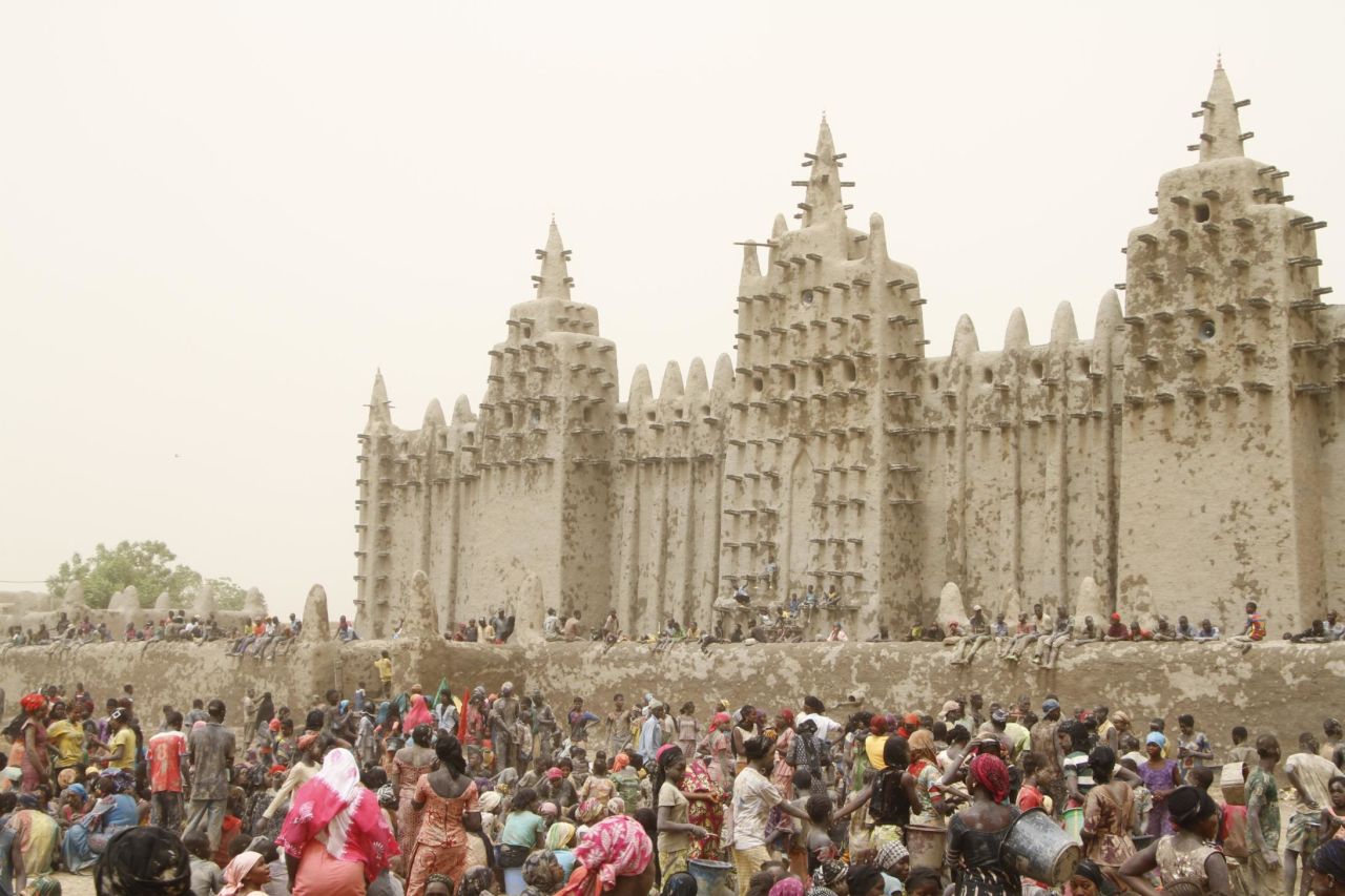Timbuktu is also home to some of West Africa's most important historical buildings. Pictured is the replastering of the Great Mosque of Djenné, an annual event that attracts hundreds of people from across the city.