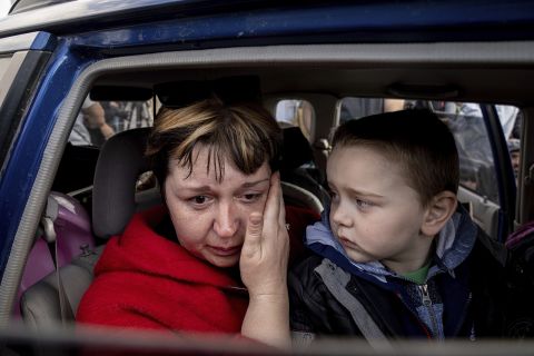 Natalia Pototska cries next to her grandson Matviy as they arrive at a center for displaced people in Zaporizhzhia, Ukraine, on Monday, May 2.