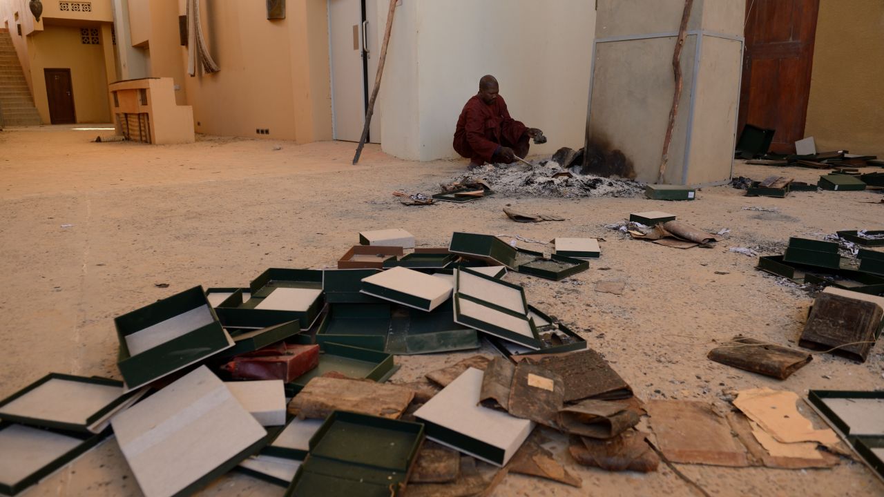 Men recover burnt ancient manuscripts at the Ahmed Baba Centre for Documentation and Research in Timbuktu on January 29, 2013.