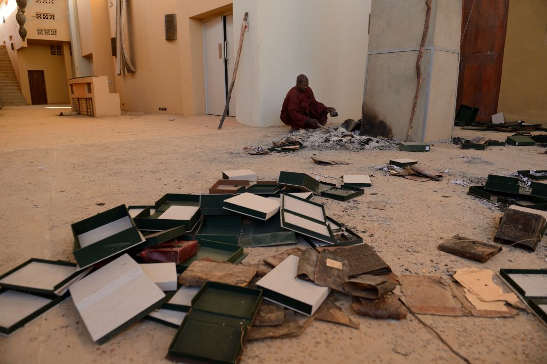 Men recover burnt ancient manuscripts at the Ahmed Baba Centre for Documentation and Research in Timbuktu on January 29, 2013. 