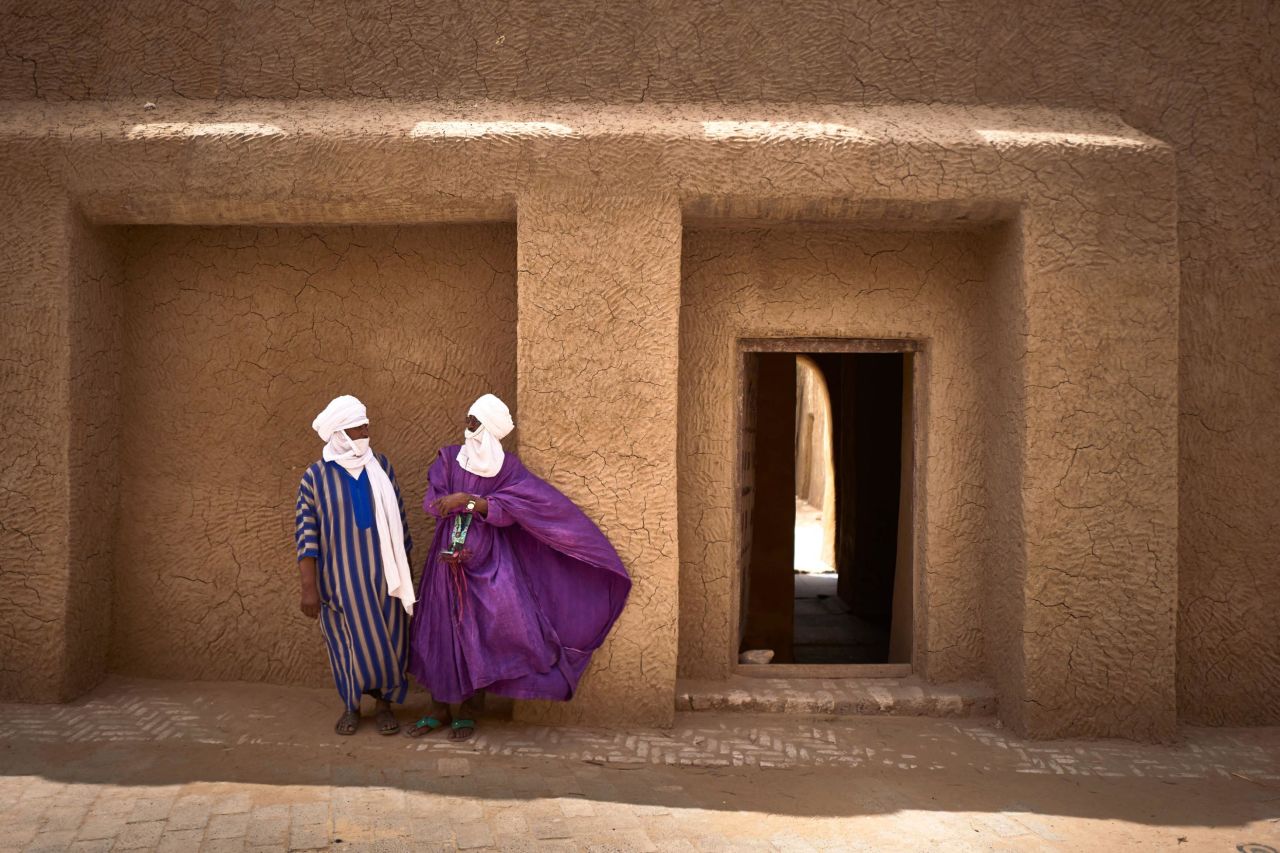 Two artisans stand in front of the Djinguereber mosque in Timbuktu on March 31, 2021. An eight-year effort from Malian archivists using equipment provided by Google has now digitized over 40,000 manuscript pages, which are available online via Google Arts & Culture hub "Mali Magic."