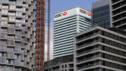 A sign sits on the HSBC Holdings Plc headquarters office building in the Canary Wharf business, financial and shopping district of London, U.K., on Friday, Sept. 18, 2020. After a pause during lockdown, lenders from Citigroup Inc. to HSBC Holdings Plc have restarted cuts, taking gross losses announced this year to a combined 63,785 jobs, according to a Bloomberg analysis of filings. Photographer: Simon Dawson/Bloomberg via Getty Images