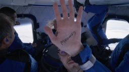 During his Blue Origin flight, Cameron Bess made a nod to the furry community by writing "Meowdy" on his hand and showing it to the on-board cameras.