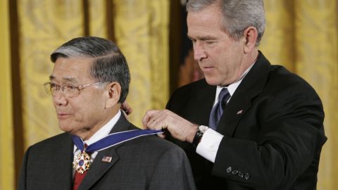 President George W. Bush, right, bestows the Presidential Medal of Freedom to former Transportation Secretary Norman Mineta during a ceremony in the East Room of the White House in Washington on Friday, December 15, 2006.