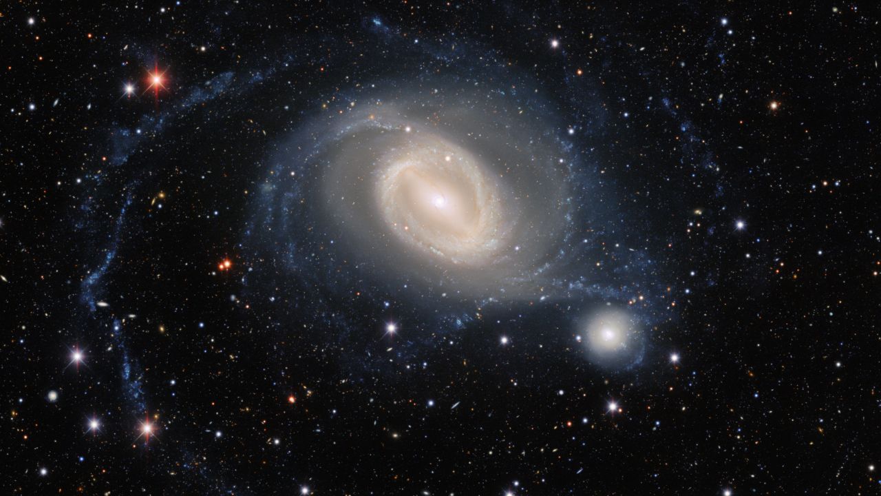 Galaxies NGC 1512 (left) and NGC 1510 swirl together in a dance that will eventually bring them together in this new image from the Dark Energy Camera.