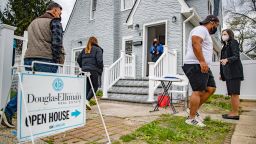 Real estate agents Rosa Arrigo, center, and Elisa Rosen, right, work an open house in West Hempstead, New York on April 18, 2021. 