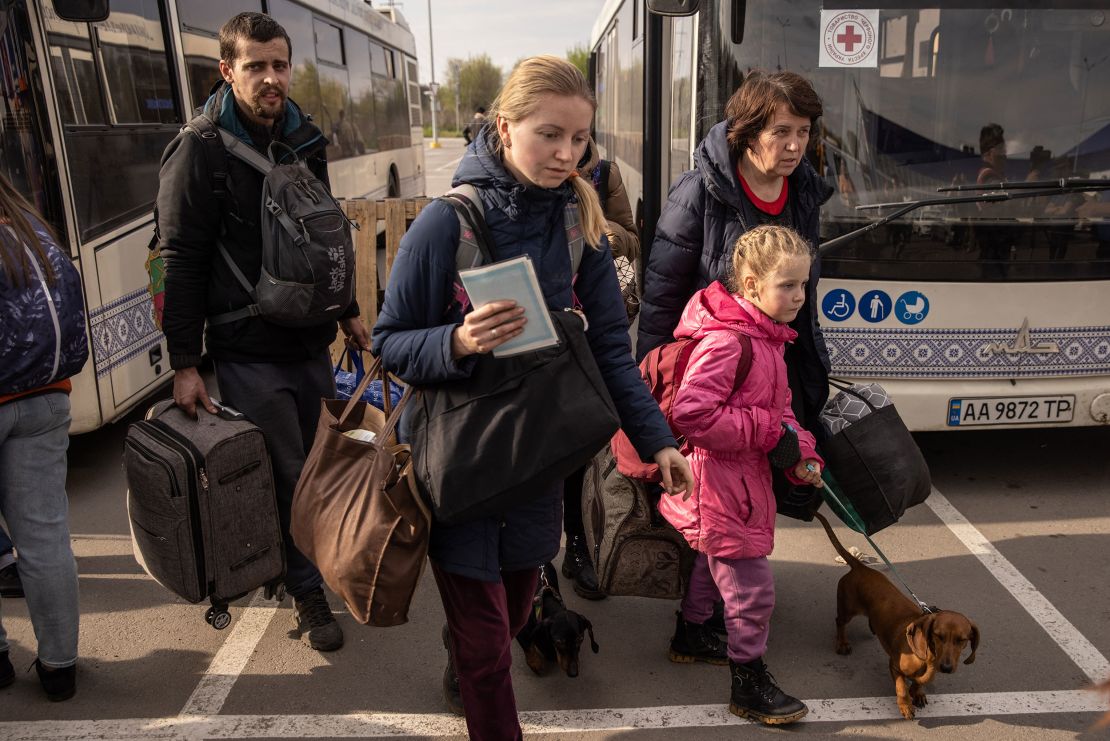 Evacuees disembark a bus after arriving in Zaporizhzhia.