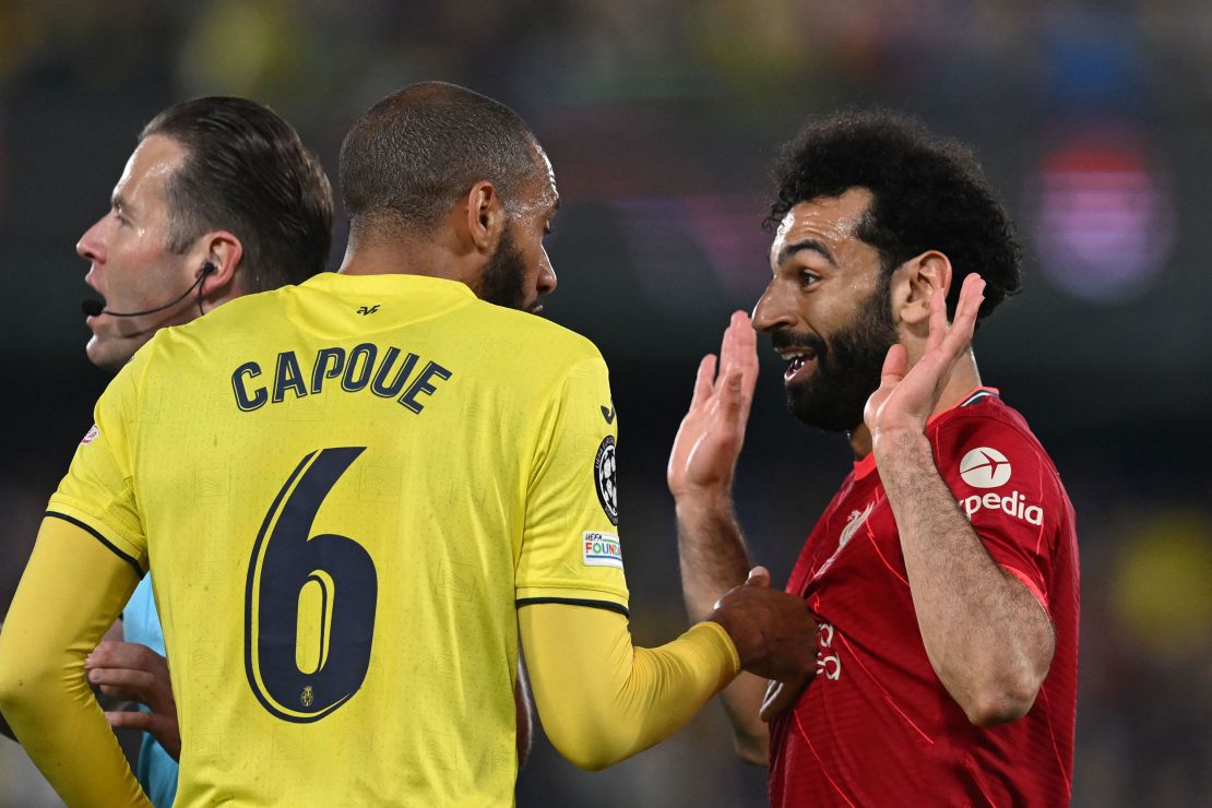 Salah argues with Capoue during the game.