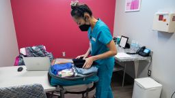 Dr. Shelly Tien, 40, changes into scrubs and puts her clothes in her backpack in her office at Planned Parenthood in Birmingham, Alabama, U.S., March 14, 2022. Dr.Tien, who flew into Birmingham late the night before from Jacksonville, Florida to perform abortions in Alabama, will fly back home at the end of the day to Florida where she is a full-time abortion doctor and and one of about 50 doctors in the United States who travels across state lines to provide abortions in states with limited abortion access.  REUTERS/Evelyn Hockstein       SEARCH "HOCKSTEIN USA ABORTION" FOR THIS STORY. SEARCH "WIDER IMAGE" FOR ALL STORIES.