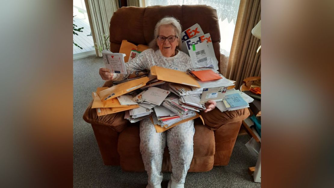 Margie poses with the letters she's received from Love For Our Elders. 