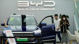 People visit a Chinese automaker BYD store on Wednesday, March 16, 2022, in Beijing. 