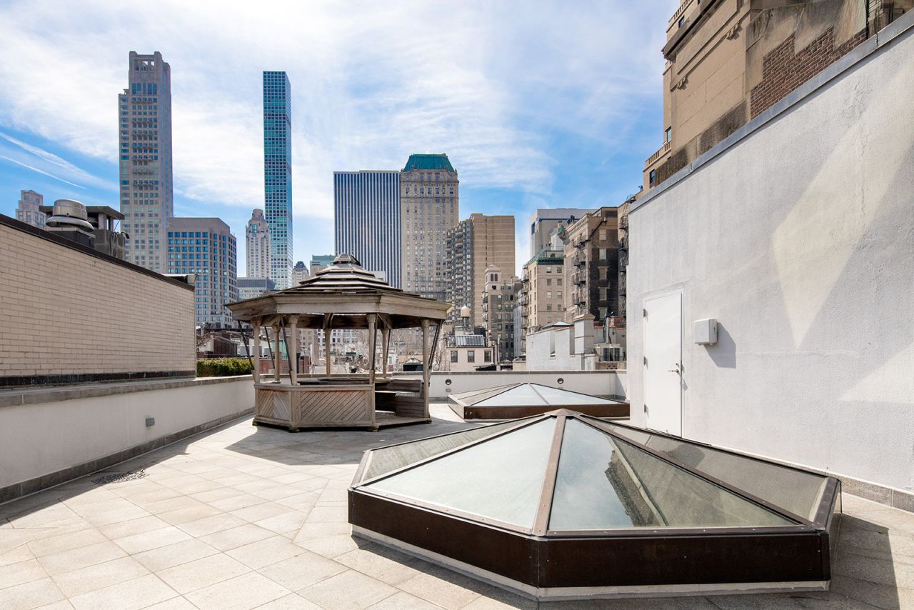 The rooftop terrace features a gazebo and offers a view of the midtown Manhattan skyline.