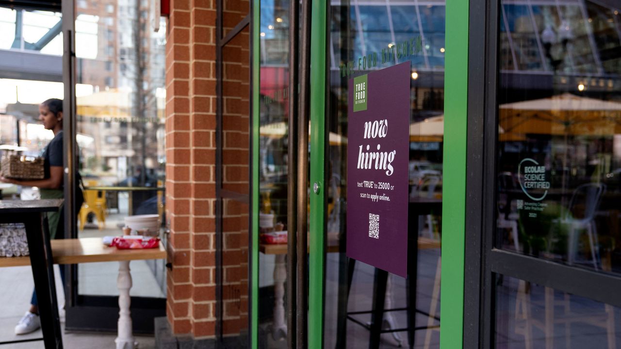 A Now Hiring sign is displayed at a restaurant in Arlington, Virginia, on March 16, 2022. - The US unemployment rate has fallen to below four percent, but many companies have continued to report challenges finding staff. Some 11.3 million jobs remained open in January, according to Labor Department figures. (Photo by Stefani Reynolds / AFP) (Photo by STEFANI REYNOLDS/AFP via Getty Images)