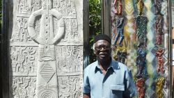 Renowned print maker Bruce Onobrakpeya speaks about his artwork at his studio in Lagos on May 3, 2017. 
At aged 84, Bruce Onobrakpeya is one of the most famous and most prolific Nigerian artists. His last work -- a sculpted stone triptych -- depicts Lagos as a magic flute player around which all Nigeria's people flock.  / AFP PHOTO / PIUS UTOMI EKPEI        (Photo credit should read PIUS UTOMI EKPEI/AFP via Getty Images)