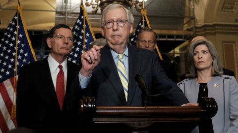 Senate Minority Leader Mitch McConnell, at center, speaks to reporters in May.