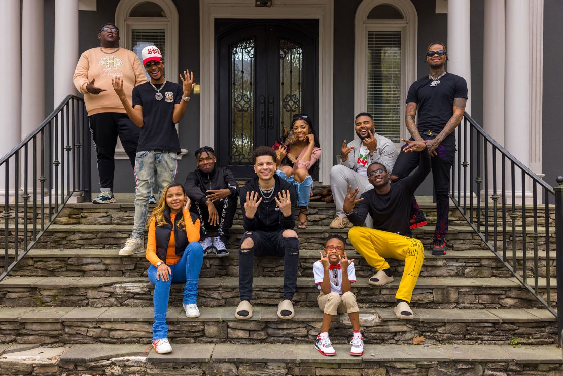 From left, Robert Dean III, Tray Bills, Khamyra Sykes, Oneil Rowe, Noah Webster, Kaychelle Dabney, Marcus Bolton, manager Keith Dorsey, Theodore Wisseh and Cameron Lee pose for a photo outside of the Collab Crib in Fayetteville, Georgia. Missing is the house's 10th creator, Kaelyn Castle. 