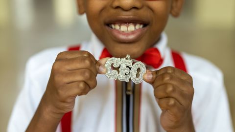 The Collab Crib's youngest member, Marcus Bolton, shows off his CEO necklace.