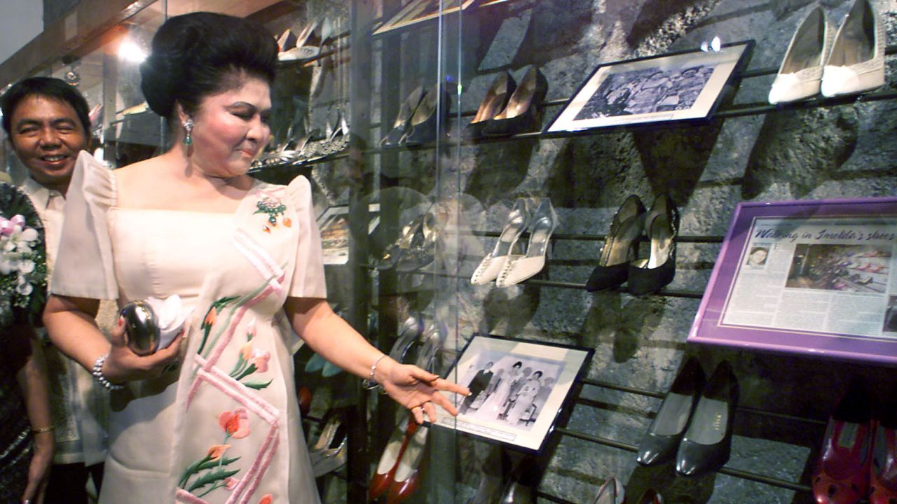 Imelda Marcos views her old shoes during the opening of a footwear museum in Manila, 2001. 