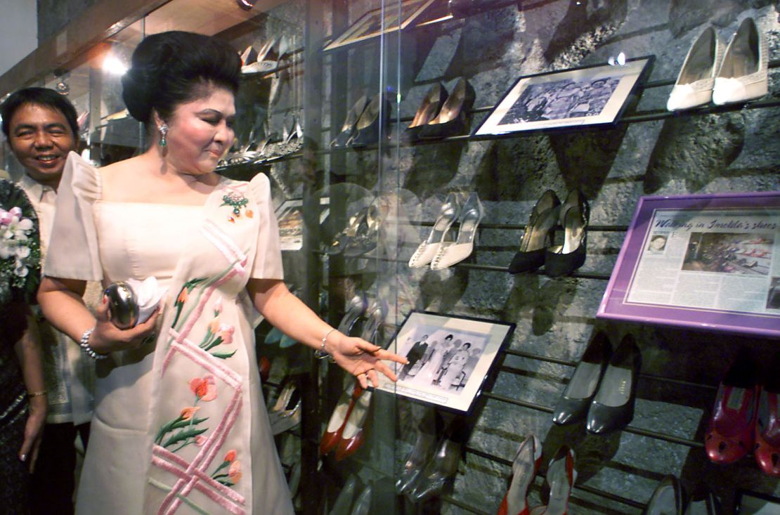 Imelda Marcos views her old shoes during the opening of a footwear museum in Manila, 2001. 