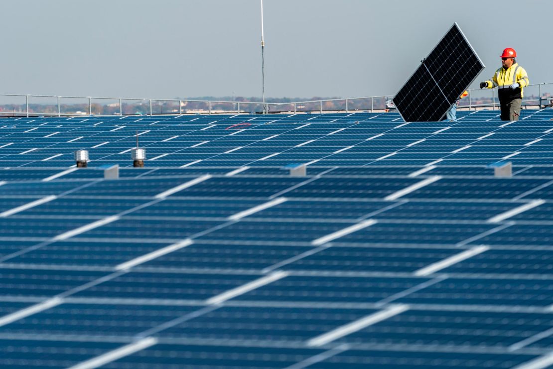 Electricians with IBEW Local 3 install solar panels on top of the Terminal B garage at LaGuardia Airport in November 2021. 