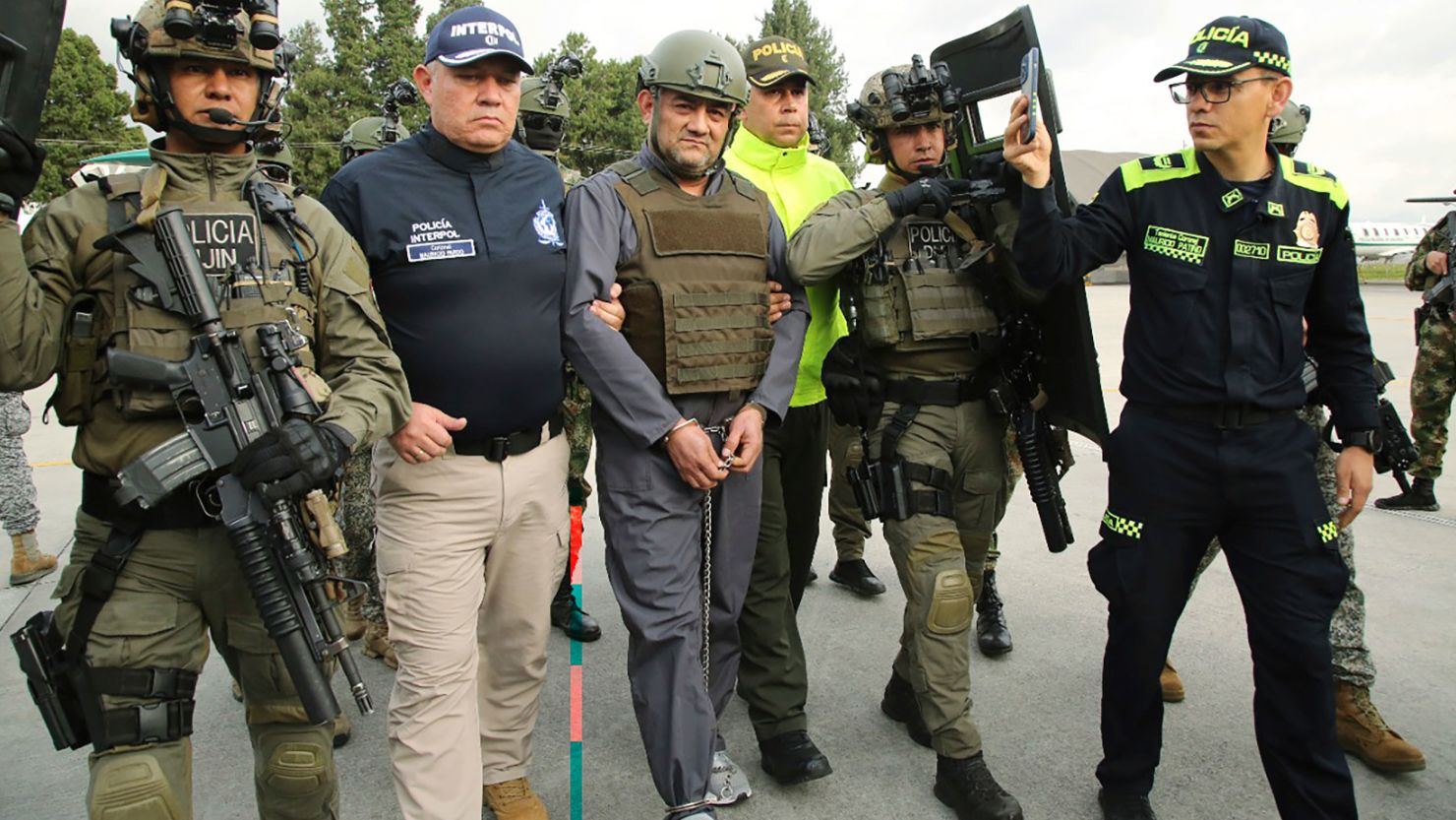 Police escort Dairo Antonio Usuga, center, also known as "Otoniel," at an airport in Colombia before his extradition to the US