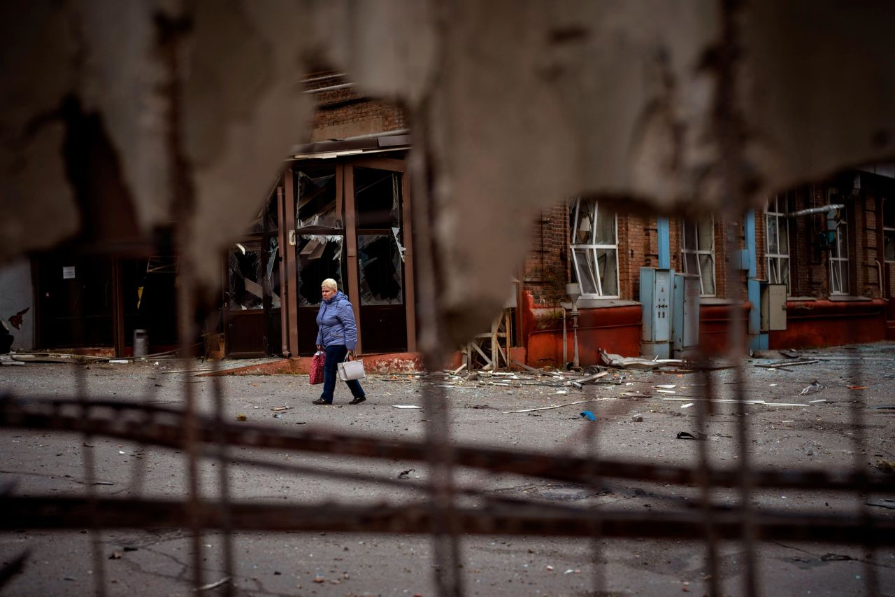 A woman walks through the site of an explosion in Kyiv on April 29. Russia <a target=