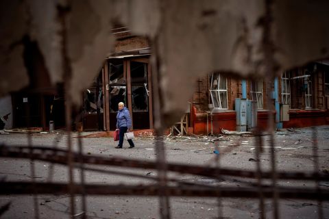 A woman walks through the site of an explosion in Kyiv on April 29. Russia <a href=