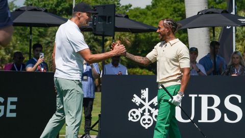 Tom Brady and Lewis Hamilton shake hands at the Big Pilot Charity Challenge at the Miami Beach Golf Club, in Miami Beach, Florida on May 4, 2022.