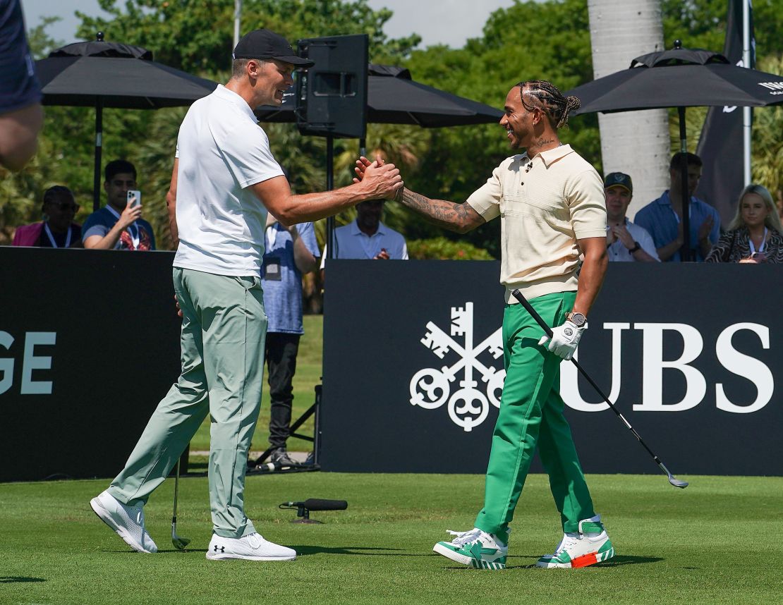Tom Brady and Lewis Hamilton shake hands at the Big Pilot Charity Challenge at the Miami Beach Golf Club, in Miami Beach, Florida on May 4, 2022.