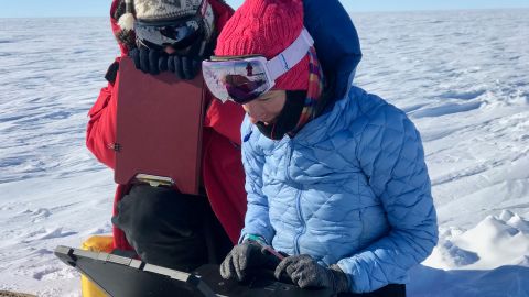The team check the data from a magnetotelluric station they used to map beneath the ice sheet.