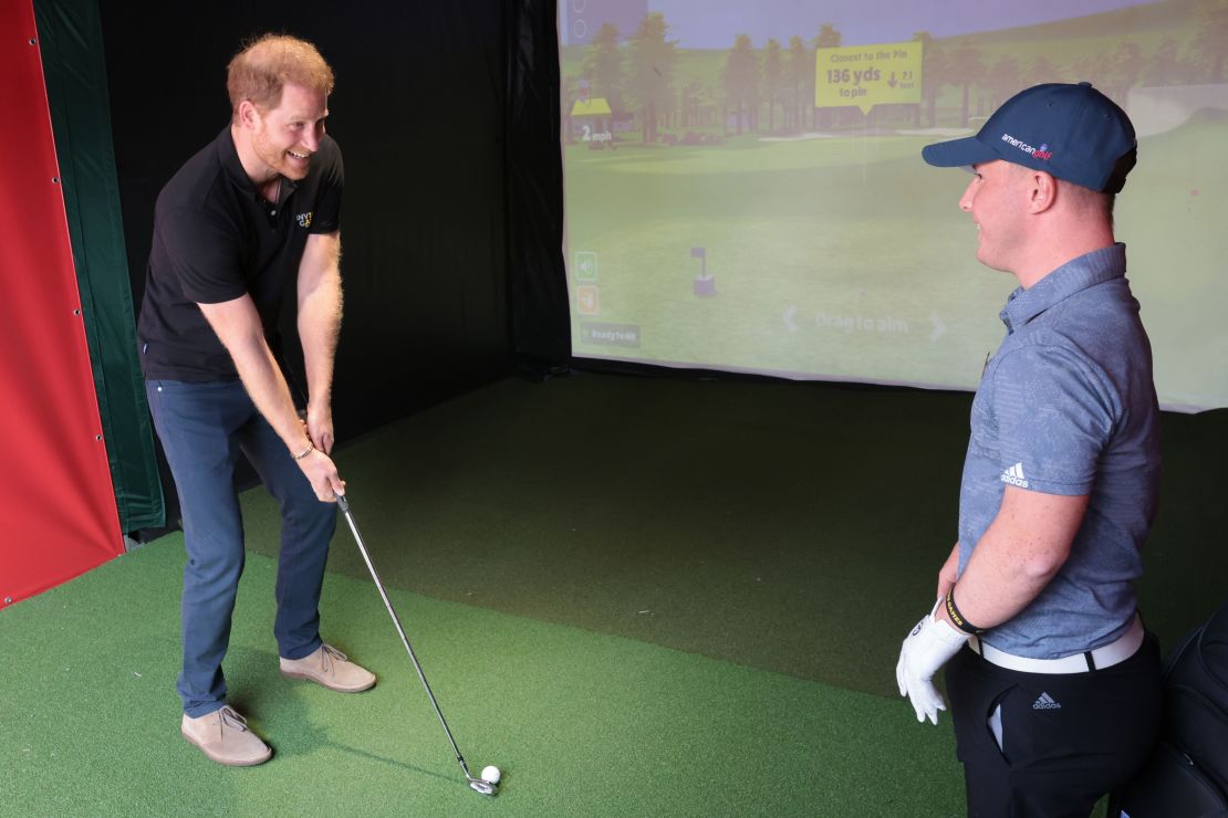 Prince Harry receives a golf lesson from Lawlor.