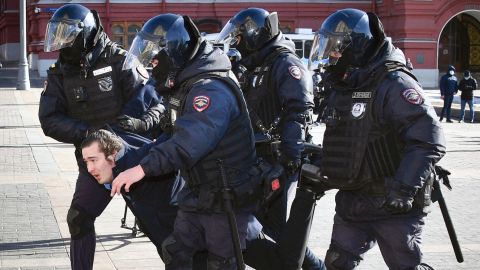 Police officers detain a man during a protest against the conflict in Ukraine, in Manezhnaya Square in central Moscow on March 13, 2022.