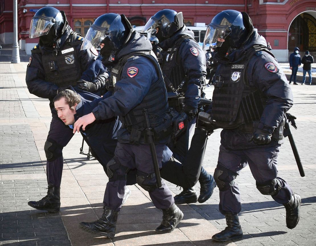 Police officers detain a man during a protest against the conflict in Ukraine, in Manezhnaya Square in central Moscow on March 13, 2022.