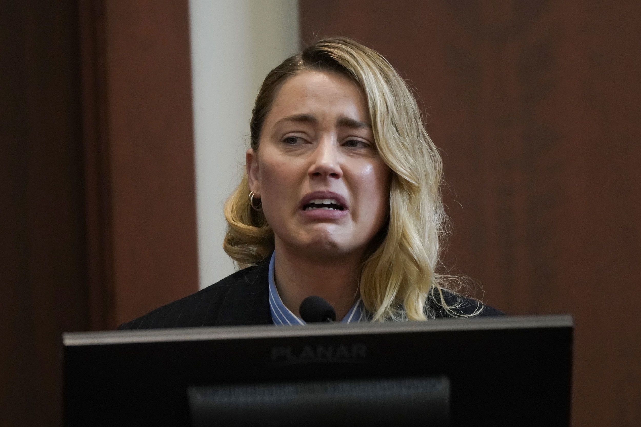 Actor Amber Heard testifies in a Virginia courtroom as she defends herself against a defamation claim.