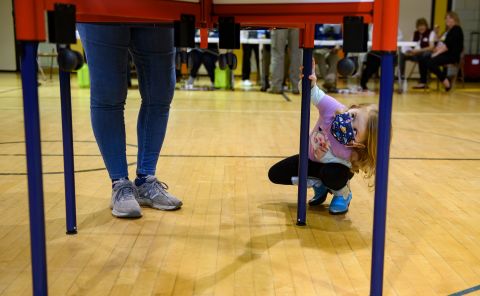 Judith Nedel fills out a primary ballot while her granddaughter, Alice, checks out the voting booth in Kent, Ohio, on Tuesday, May 3.