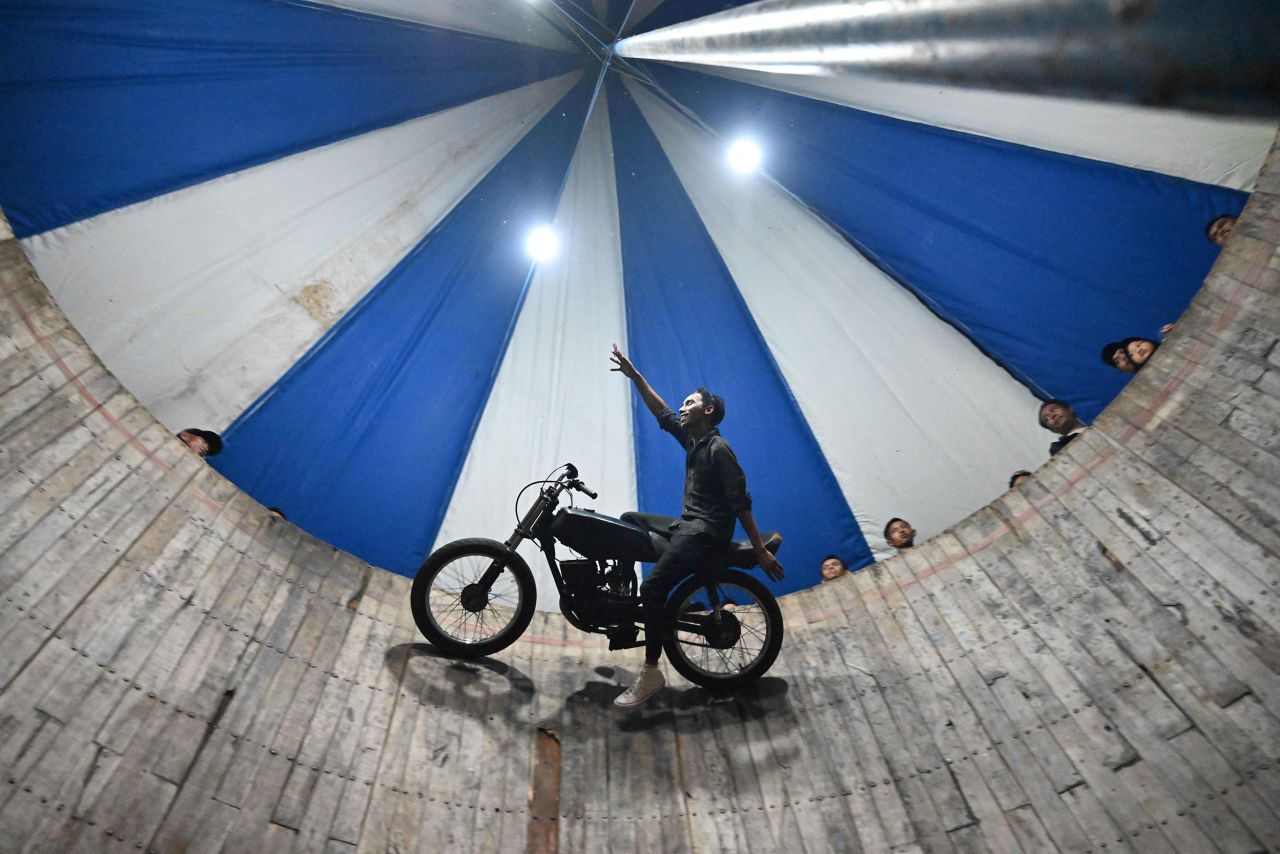 A rider performs inside a "wall of death," known locally as a tong stand, during a carnival in Bogor, Indonesia, on Saturday, April 30.