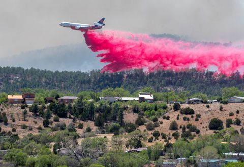 An aircraft dumps fire retardant in Las Vegas, New Mexico, on Tuesday, May 3. Wildfires and straight-line winds <a href=